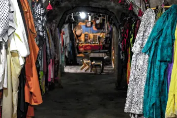 Harran Kümbet Evi'nin iç mekanında geleneksel giysiler, dokumalar ve yöresel süslemeler.